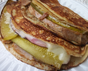 roast pork, smoked ham, and swiss cheese grilled in crepes
