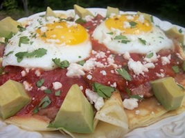 cornmeal crepes topped with fried eggs, refried beans and salsa