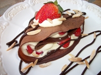 strawberries and almond cream in dark chocolate crepes