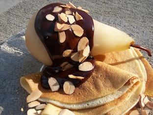 Warm Poached Pears Coated in Chocolate Over Dessert Crepes