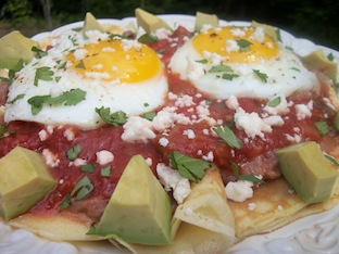 fried eggs over cornmeal crepes with refried beans and salsa