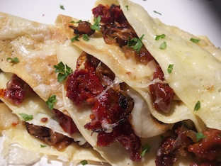 sun dried tomatoes and onions in roasted garlic crepes