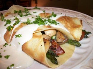 swiss cheese sauce over asparagus mushroom crepes